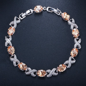 Elegant XO silver bracelet featuring champagne stones and sparkling zircon accents