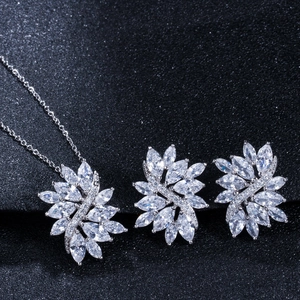 Detailed close-up of zircon marquise-cut necklace and earrings jewelry set on dark background