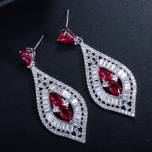 Primer plano de pendientes de plata con circonita roja y detalles de pavé micro