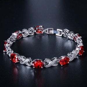 Elegant silver bracelet with red oval zircon and X-shaped link design with micro-pave stones