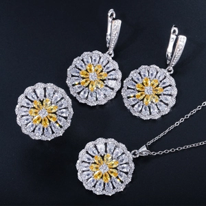 Macro detail of sunflower jewelry set featuring yellow zircon and silver metal finish