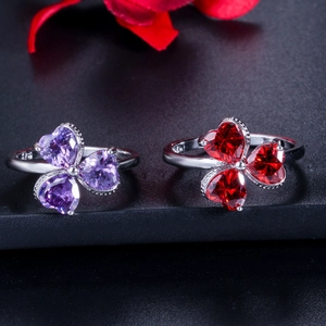 Detail of 925 sterling silver rings featuring three-leaf clover designs with purple and red gems