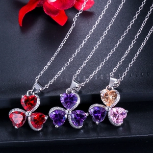 Three-leaf clover zircon jewelry set featuring heart-cut crystals on silver link chains