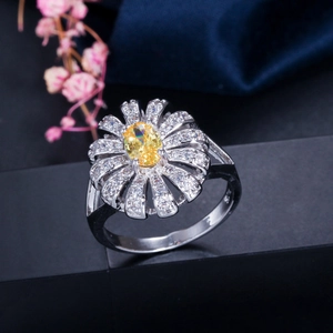 Floral sterling silver ring with oval yellow gemstone and sparkling zircon accents