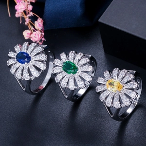 Detailed close-up of daisy rings featuring micro-set zircon in blue, green, and yellow