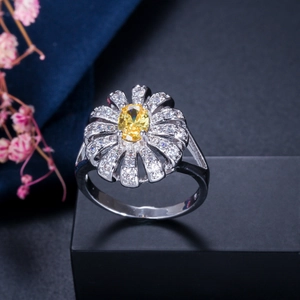 Macro shot of silver flower ring with yellow gemstone and pavé cubic zirconia