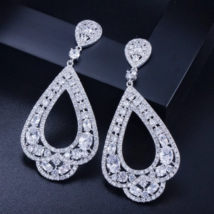 Détail de boucles d'oreilles poires avec pavage de zircons AAA étincelants sur fond noir
