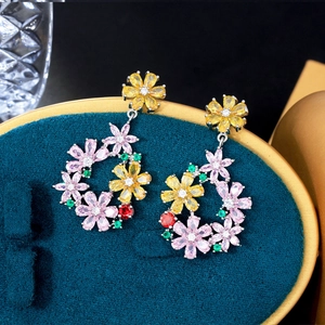 Macro shot of colorful zircon flower earrings on dark velvet, showcasing fine gemstone detail