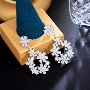 Detailed macro view of S925 silver flower drop earrings with sparkling cubic zirconia gems