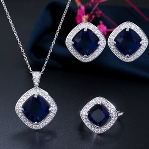 Three-piece jewelry set with square blue gemstones and micro-paved cubic zirconia