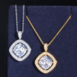 Detailed view of silver and gold cushion cut necklaces with micro-pave cubic zirconia