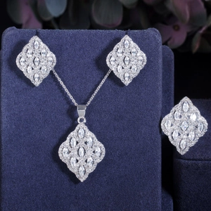 Elegant silver jewelry set with marquise zircon necklace, earrings and ring on blue display