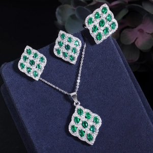 Detailed view of marquise-cut green gemstone jewelry set with silver necklace and rings