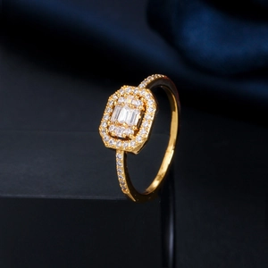Macro shot of gold-plated octagonal halo ring with baguette-cut and pavé cubic zirconia