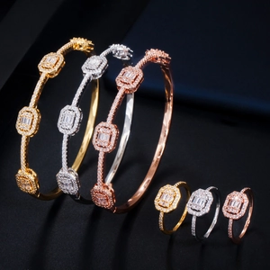 Macro view of geometric bangle and ring set with micro-paved sparkling cubic zirconia