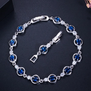 Detailed shot of a silver zircon bracelet with navy blue stones and folding clasp