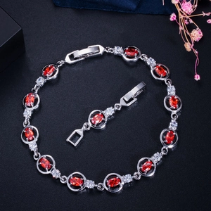 Silver bracelet with oval red zircons and white crystals, includes an extra clasp extender