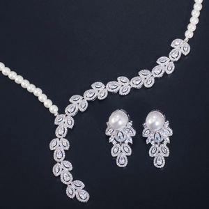 Elegant pearl and zircon necklace and earring set with leaf-shaped diamond accents