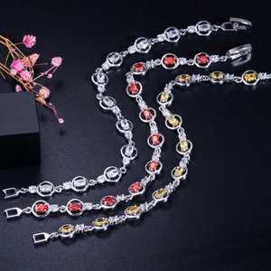 Detail of elegant silver bracelets with AAA zirconias in white, red and yellow gems