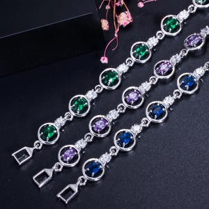 Macro detail of oval cut emerald and amethyst bracelets with pave zircon borders