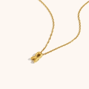 Detail of 18K gold-plated hollow letter R pendant on a delicate cable chain necklace