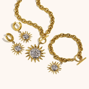 Detail view of gold and silver sun face jewelry set with toggle clasp and thick chain
