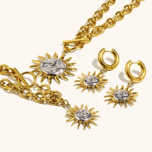 Detail of 18K gold plated sun face pendant necklace and matching hoop earrings set