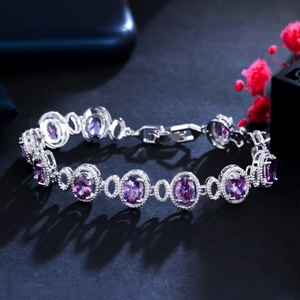 Macro shot of silver bracelet with oval purple crystals and micro-pave zirconia details