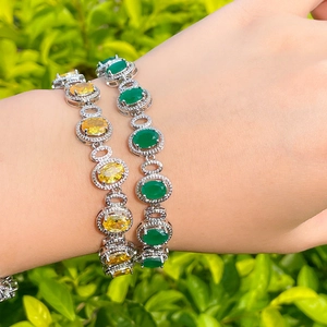 18K gold plated brass bracelets with oval sapphire and zircon worn by a model