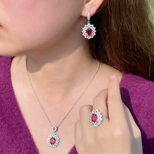 Elegant ruby jewelry set with oval gemstones and zircon halos on model