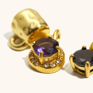 18K gold plated stainless steel pendant featuring a purple zircon and hammered metal details