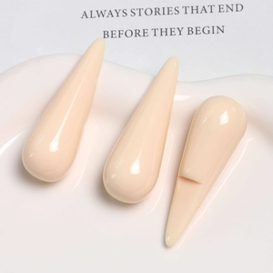 Detailed view of three nude water drop resin pendants displayed on a white ceramic plate