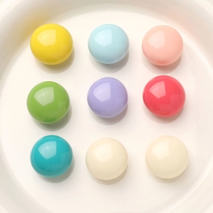Colorful macaron resin beads for DIY jewelry and crafts arranged in a white ceramic dish