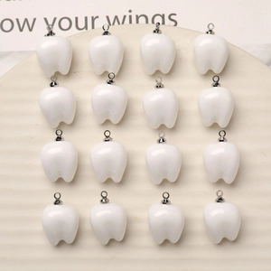 Creative white resin tooth charms with silver loops arranged in a 16-piece grid display
