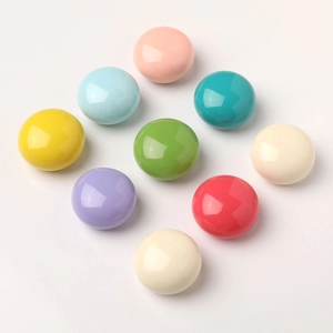 Macro shot of colorful round resin cabinet knobs in nine macaron pastel colors