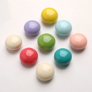 Macro view of colorful glossy resin round cabinet knobs in various pastel macaroon colors