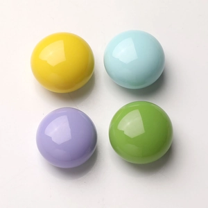 Macro shot of colorful glossy resin beads in pastel yellow blue purple and green tones