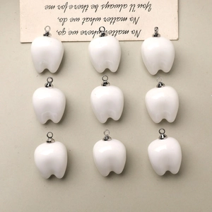 Set of nine cute white resin tooth charms with silver metal rings for DIY jewelry making