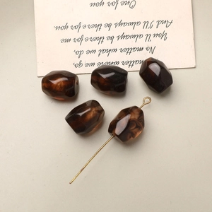 Detailed view of amber resin faceted beads with marble texture for DIY jewelry making