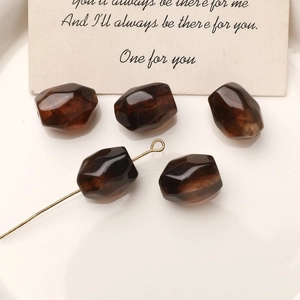 Close-up of geometric amber faceted beads for DIY jewelry with smooth resin texture