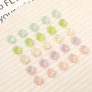 Macro detail of 10mm iridescent resin rose charms in various pastel colors for DIY crafts