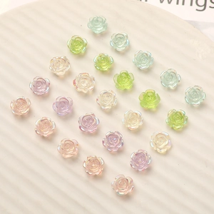 Macro view of 10mm iridescent resin rose charms in pastel colors for DIY nail art crafts
