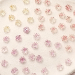 Detailed view of 8mm resin camellia rose charms with gold foil for DIY nail art design