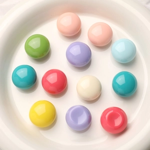 Colorful macaron resin dome beads for DIY jewelry and phone case decoration in a white dish