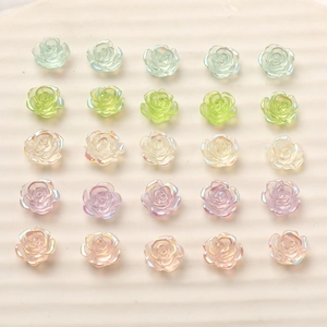 Macro view of 10mm resin rose charms with iridescent pearl finish for DIY nail art