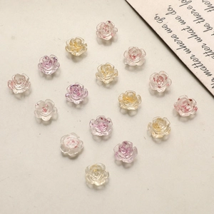 Detail of camellia nail art charms with gold leaf and translucent resin petals