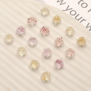 Macro shot of 8mm resin camellia charms with gold foil for DIY nail art decoration