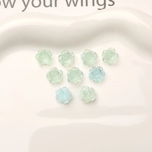 Macro view of 10mm mini resin rose charms with AB aurora finish for DIY nail art