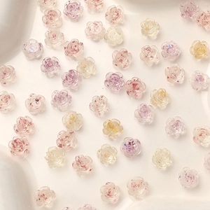 Macro shot of 8mm camellia flower resin charms with gold foil for DIY nail art design