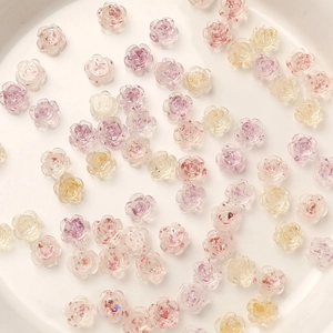 Detail of 8mm camellia nail art charms with gold foil and translucent resin finish